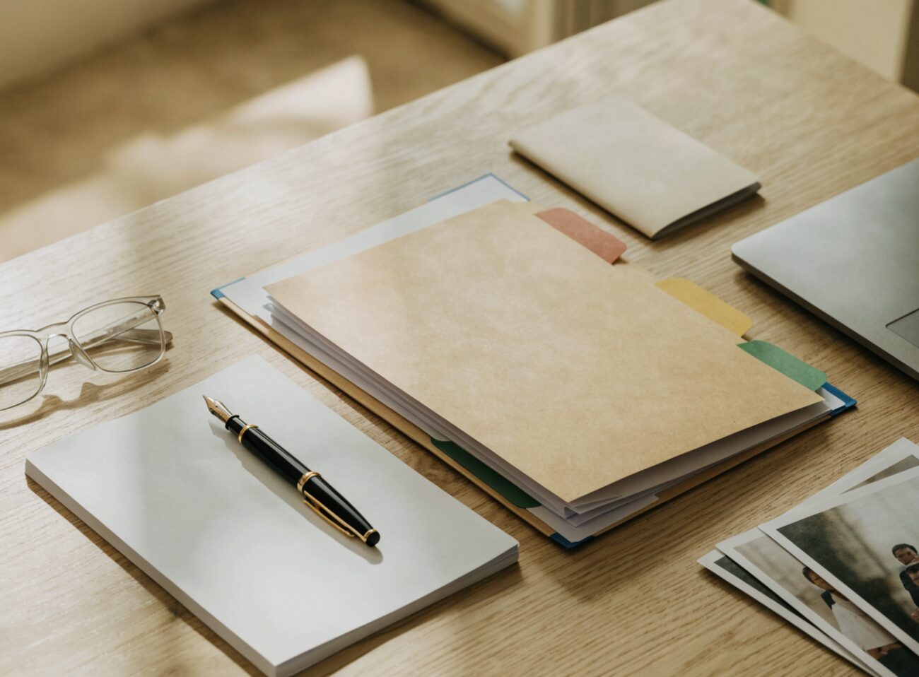 An organized set of immigration forms, tabbed folders, and supporting documents laid out on a desk